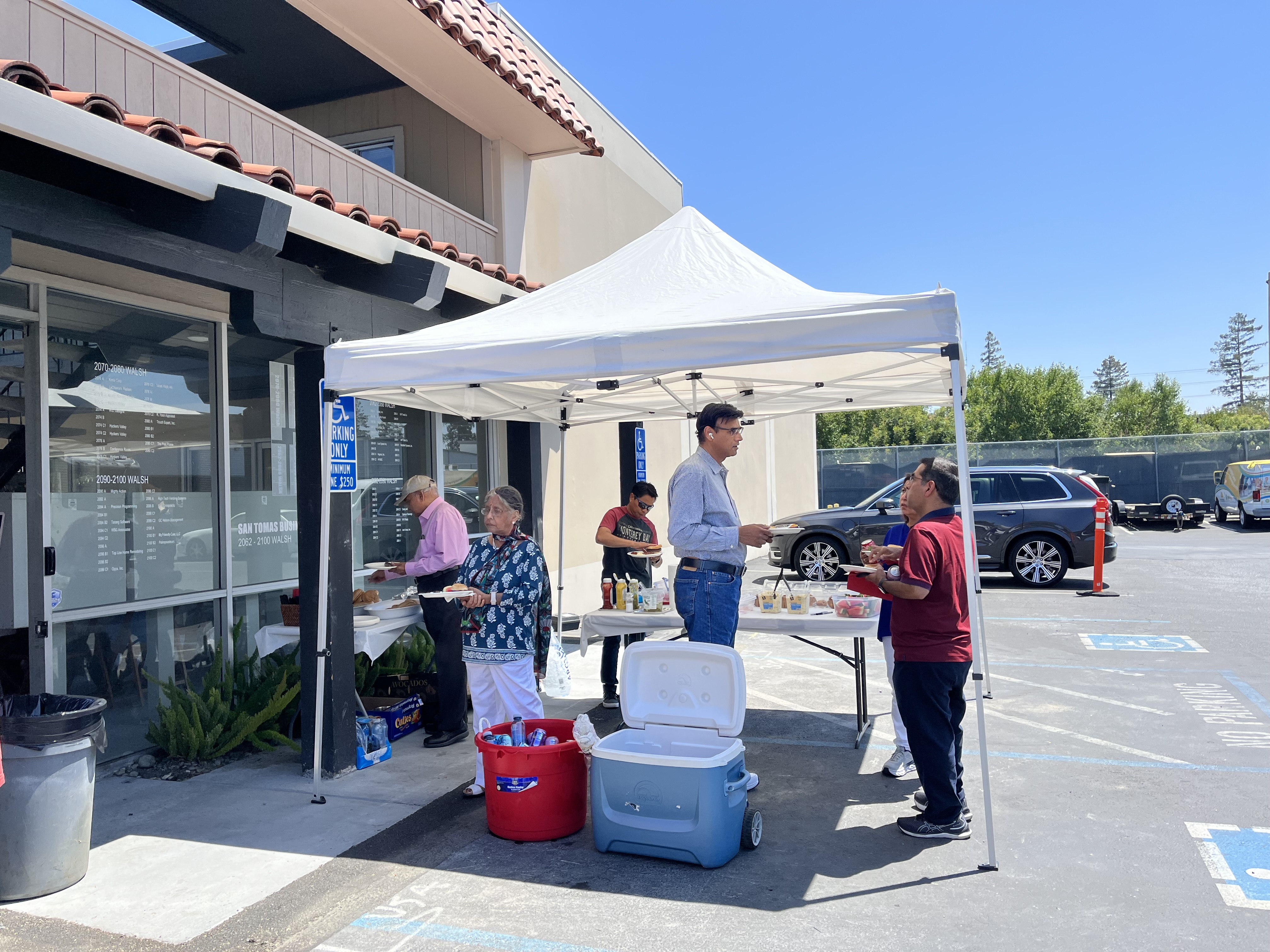 People sharing food in the sun at San Tomas Business Centre